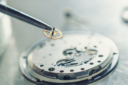 tweezers and disassembled mechanical watches