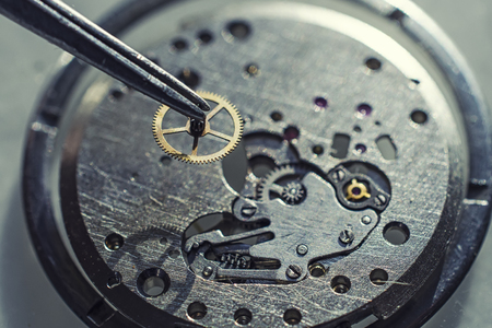 tweezers and disassembled mechanical watchesの写真素材