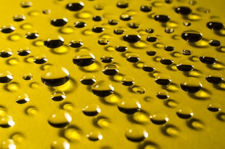drops of water on yellow  backgroundの写真素材