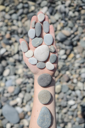 Woman hands holding stones. Concept for balanceの写真素材
