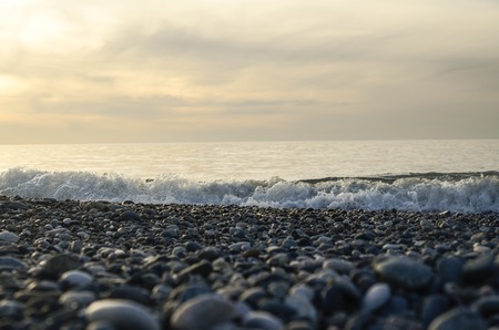 Sunset at sea. Seascape, waves, pebbles, skyの写真素材