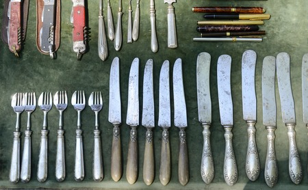 collection of knives and spoons at  street marketの写真素材