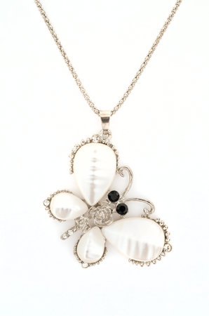 Pendant with butterfly isolated on whiteの写真素材