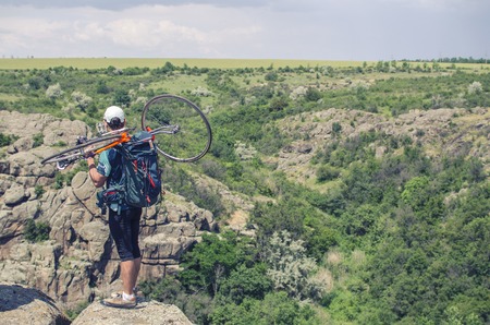 man with the bike on the mountainの写真素材