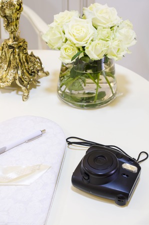 table with flowers and instant print cameraの写真素材