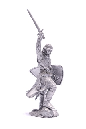 tin soldier medieval knight with sword and shield isolated on whiteの写真素材