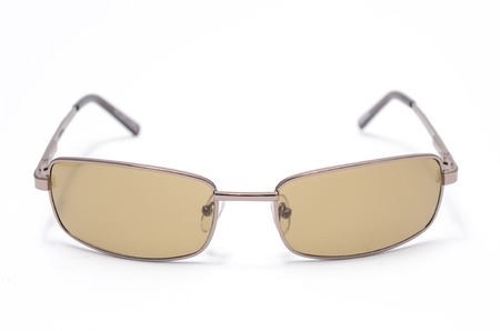 Men's sunglasses with brown glasses in metal frame isolated on whiteの写真素材