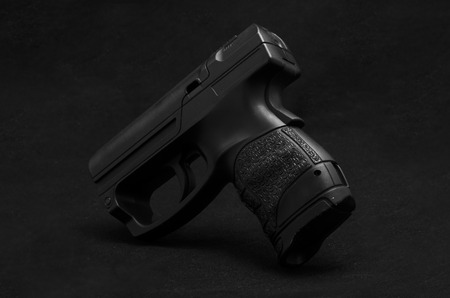 Black pistol on black backgroundの写真素材