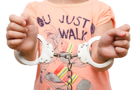 Girl, child in handcuffs isolated
