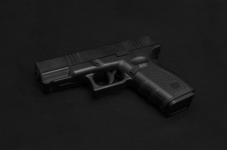Black pistol on black backgroundの写真素材
