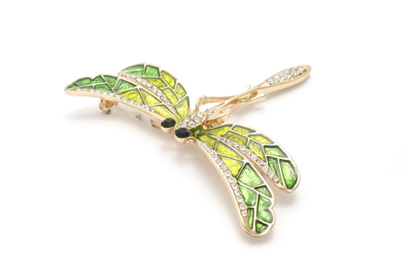 enamel brooch with golden dragonfly with diamonds isolated on whiteの写真素材