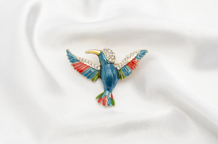 enamel brooch with Hummingbird and diamonds on silk fabricの写真素材