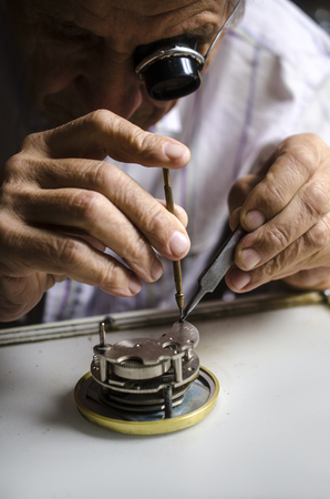 old watchmaker at workの写真素材