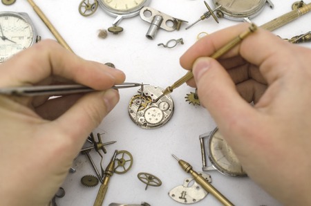 Repair of mechanical watches isolated on whiteの写真素材