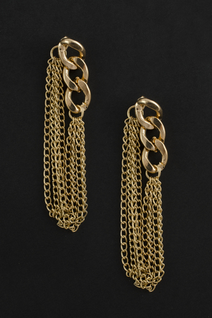 gold chain earrings isolated on blackの写真素材