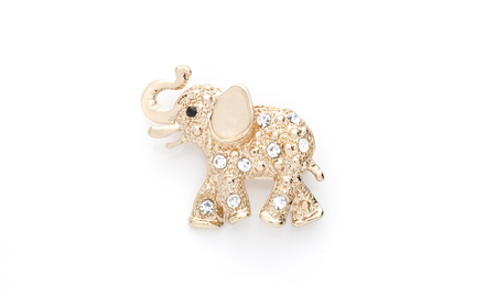 gold elephant brooch isolated on whiteの写真素材