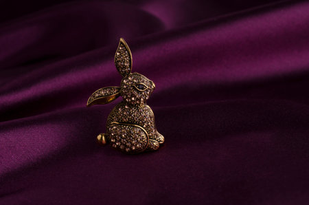 gold brooch bunny with diamonds on silkの写真素材