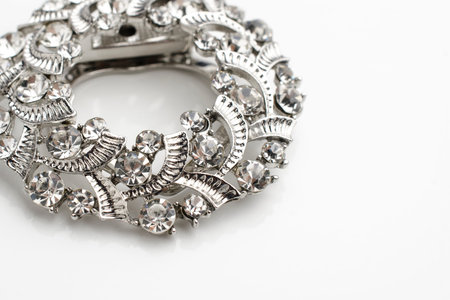 round brooch with diamonds isolated on whiteの写真素材