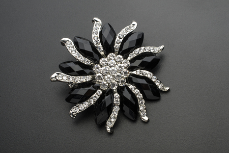 round brooch flower with gems stones isolated on blackの写真素材