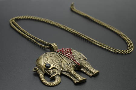 gold pendant elephant isolated on blackの写真素材