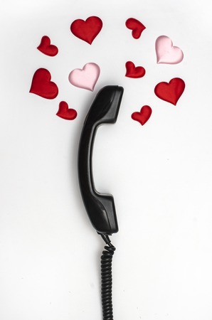 retro telephone handset with hearts isolated on whiteの写真素材