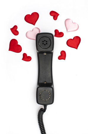 retro telephone handset with hearts isolated on whiteの写真素材