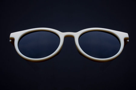 round retro sunglasses in plastic rim isolated on black