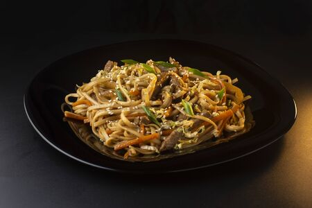 noodles with beef carrots, herbs and sesame seedsの写真素材