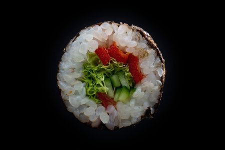 single maki roll isolated on black background