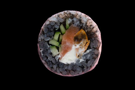 one sushi roll close up on black backgroundの写真素材