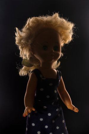 sinister doll, face in shadow, hair highlightedの写真素材