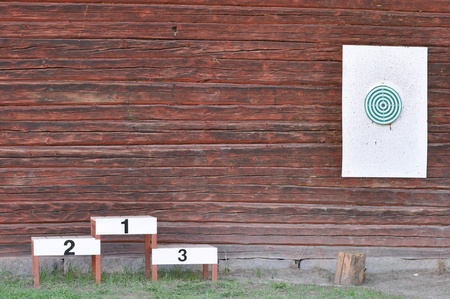 The darts sport game on red wood wall outdoors.の写真素材