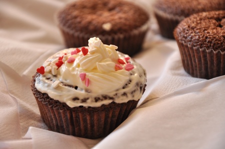 Chocolate cakes with cream and sweet hearts.の写真素材