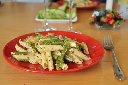 Macaroni with vegetables and spices in plate on table.の写真素材