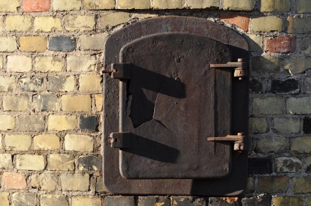 Rust brown door in brick colourful wall の写真素材