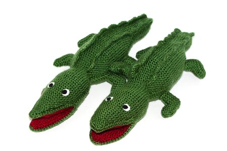 Pair of green crocodiles homemade knitted toy on whiteの写真素材