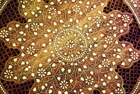 Wooden background with floral ornamental pattern and metall elementsの写真素材