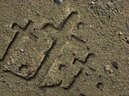 Crosses carved in the sand from water wave