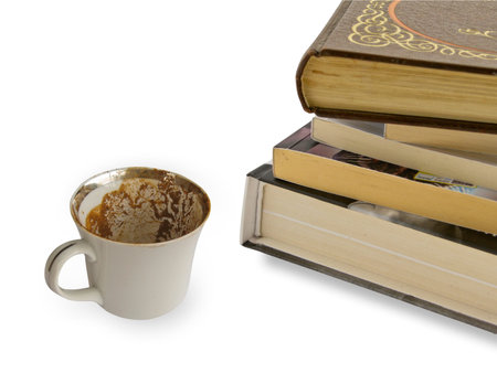 A pile of class books with Empty coffee cup isolated on whiteの写真素材