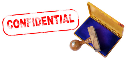 Top view of a rubber stamp with a giant word "CONFIDENTIAL" printed, isolated on white background.の写真素材