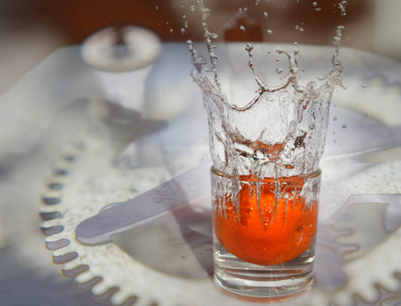 orange fruit  is falling and splashing into water incolor .   Concept of timeの写真素材