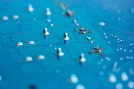 The reverse side of the microboard on a blue background. Electronic board with electrical components, computer equipment. High quality photoの写真素材