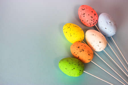 Multicolored Easter decorative eggs on a gently blue background. Easter minimalistic background. Space for text. High quality photoの写真素材
