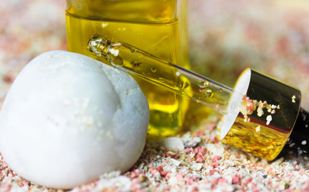 Golden yellow oil serum in pipette. Natural organic cosmetic product for facial skincare and skin...