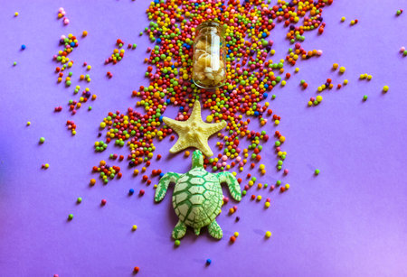 Starfish, turtle, bottle with seashells flatly. Bright foam multi-colored balls on a purple...