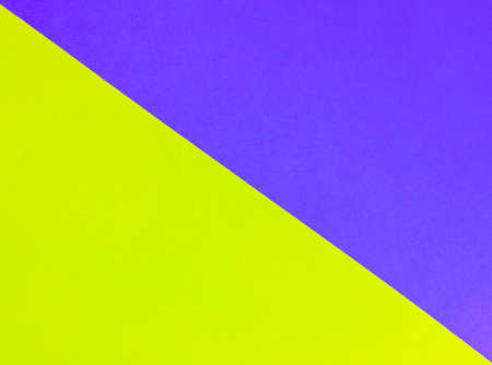 Yellow-blue or green-purple bright minimalist geometric background divided in half by a diagonal stripe. Abstract wallpaper. Colors of a Ukrainian flag. Colored paper template with place for text.の写真素材