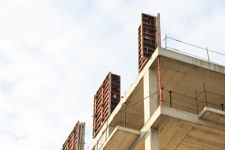 Concrete construction of a new high-rise apartment building. An unfinished buildings facade view...