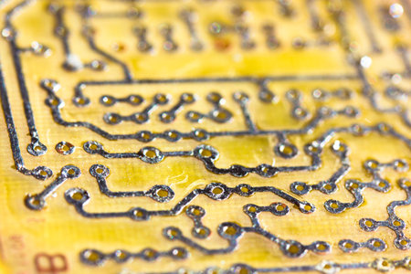 Printed yellow circuit board close-up. Electronic computer hardware technology macro photo. A...