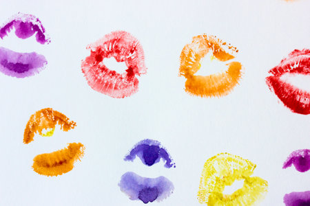 Set of multicolored female lip prints on white paper background top view. Kisses flatly. Lipstick prints, marks. Femininity, flirt, love concept. World Kissing Day. Valentines Day. Lovely backdrop.の写真素材