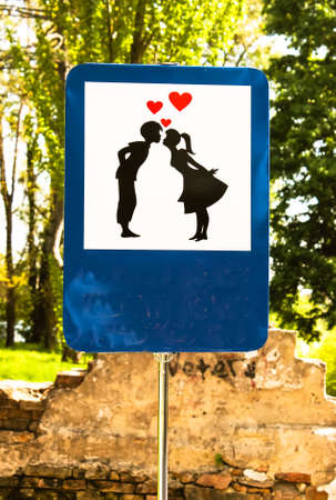 Kiev, Ukraine. May 1, 2019. A sign depicting a kissing couple of a girl and a boy. Kissing spot. Romantic walk in the park. First feelings of love, affection, passion, mutual feelings concept. Kiss meのeditorial素材